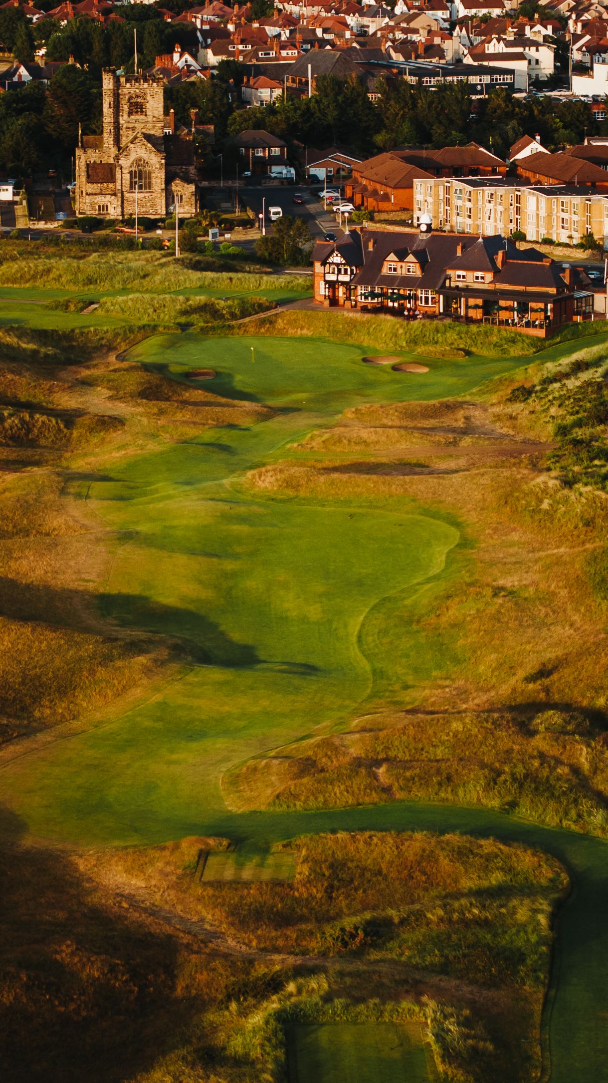 The eighteenth from the air, the fairway running up through the dunes to the clubhouse
